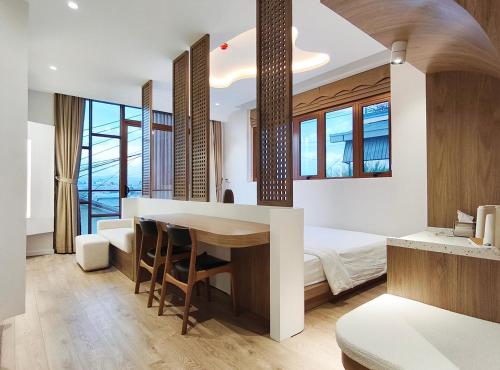 a bedroom with a bed and a table with chairs at Meraki Villa Đà Lạt in Khu Chi Lăng