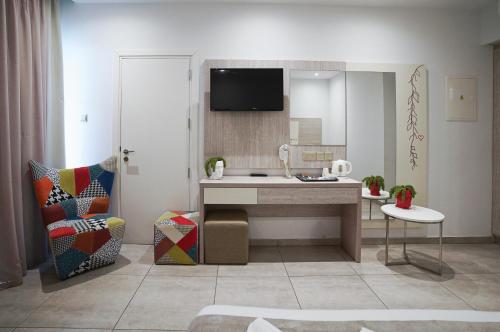 a bathroom with a sink and a mirror at Nicholas Color Hotel in Ayia Napa