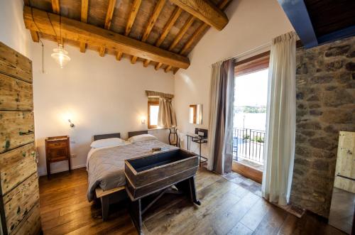 a bedroom with a bed and a large window at Al Vicolo dei Pescatori in Anguillara Sabazia