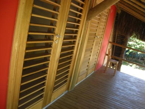a wooden staircase in a room with a window at Bed & Breakfast Casa Dos Cajueiros in Barra Grande