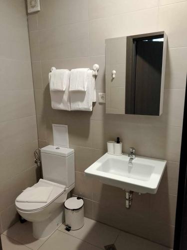 a bathroom with a toilet and a sink at Черно море, Кранево, студио 2 in Kranevo