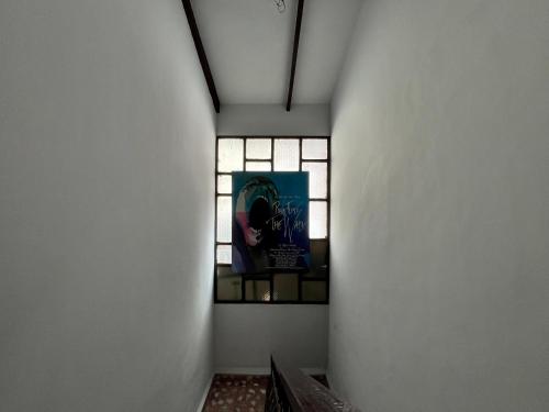 a hallway with a stained glass window in a building at El Pueblito in Cochabamba