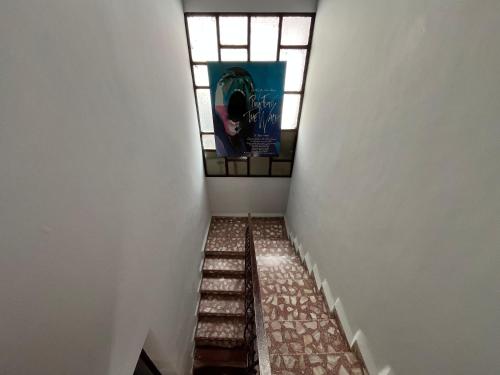 a hallway with a stained glass window and stairs at El Pueblito in Cochabamba