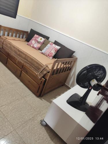 a bedroom with a bed with a fan and a camera at Sobrado Aviação piscina, churrasqueira, jacuzzi in Praia Grande
