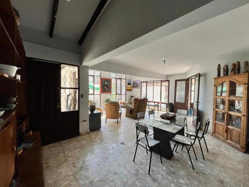 a living room with a table and chairs at El Pueblito in Cochabamba