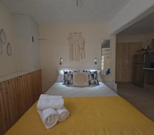 a bedroom with a large bed with towels on it at Almyra in Finikounta