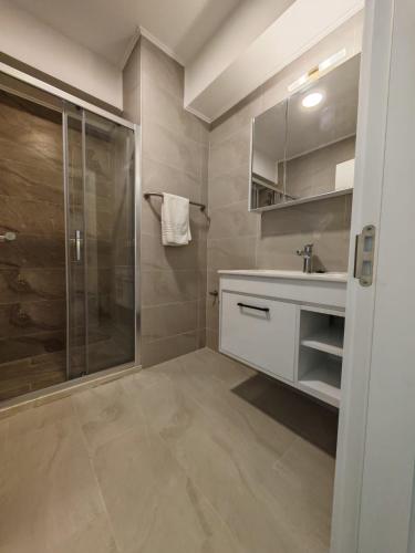 a bathroom with a glass shower and a sink at Cazare Apartmente in SolidHouse Mamaia in Mamaia