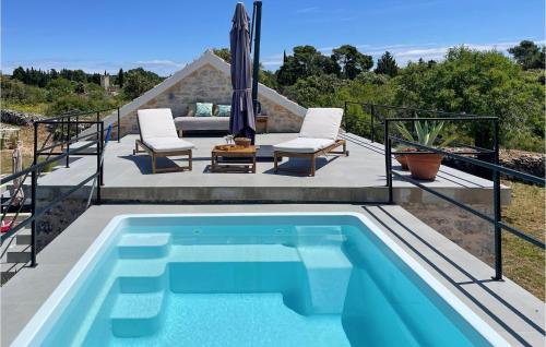 a swimming pool on a patio next to a house at 2 Bedroom Gorgeous Home In Gdinj in Gdinj