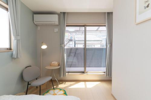 a small room with a bed and a window at NEW OPEN Comfortable newly built house stay 2-minute walk from Bentencho Station in Osaka
