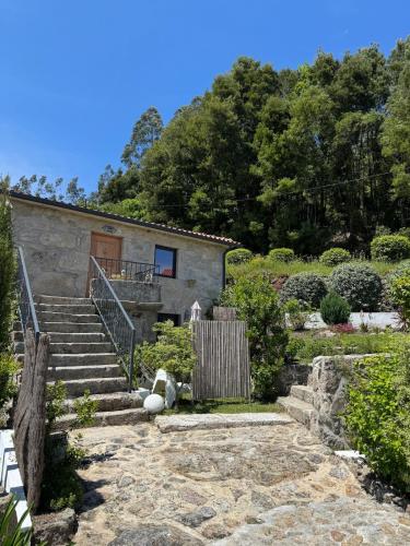 a house with stairs and a teddy bear in front of it at Quinta da Lembrança in Arcos de Valdevez