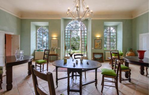 a dining room with tables and chairs and a chandelier at Gorgeous Home In Porto San Giorgio in Porto San Giorgio
