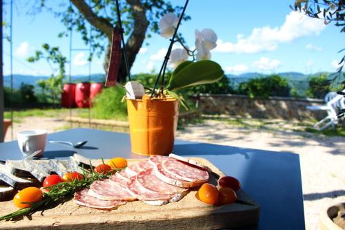 a cutting board with meat and vegetables on a table at Nuit de Légende en Beaujolais in Lantignié-en-Beaujolais