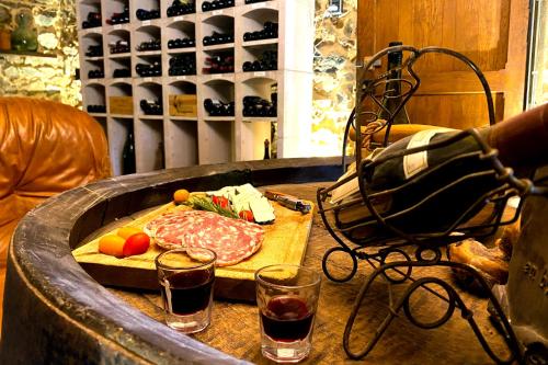 a table with a steak on a cutting board and drinks at Nuit de Légende en Beaujolais in Lantignié-en-Beaujolais