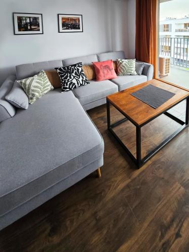 a living room with a couch and a coffee table at Schindler’s Factory Zabłocie Deluxe Apartments WAWELOFTS in Kraków