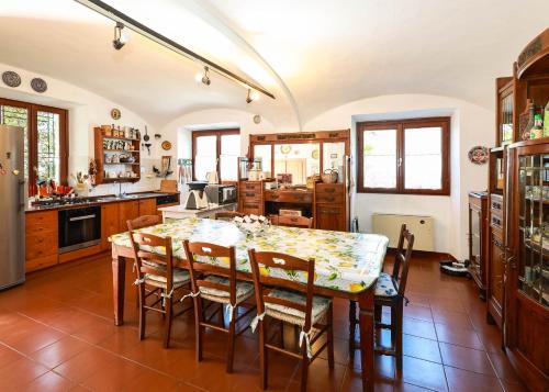 a kitchen with a dining room table and chairs at Residenza La Motta - Pettenasco in Pettenasco