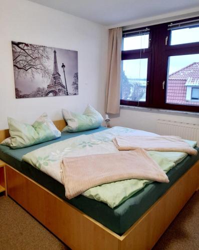 a bedroom with a large bed with a window at Großzügige, komfortable Wohnung in Burgstaedt