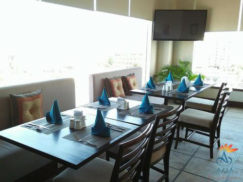a dining room with a long table with blue napkins at Azia Suites and Residences in Cebu City