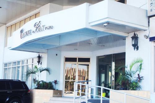 a building with a sign on the front of it at Touristation @ Crowne Bay Tower in Manila