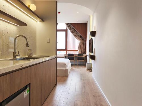 a kitchen with a sink and a living room at Meraki Villa Đà Lạt in Khu Chi Lăng