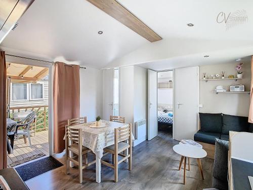 un salon avec une table et un canapé dans l'établissement Mobil-Home CL 18 à Vias - La Carabasse - Camping Siblu avec piscine, à Vias