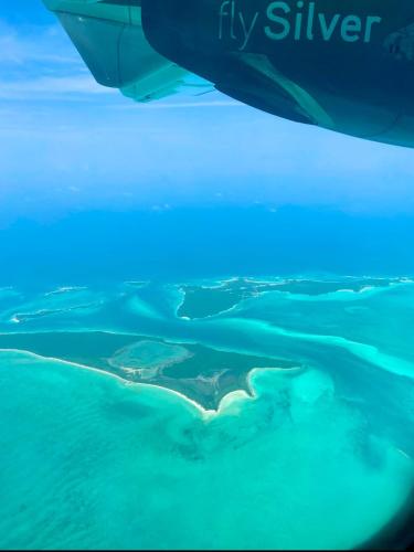 an island in the ocean with blue lights on it at Best Location In Exuma - George Town in Georgetown