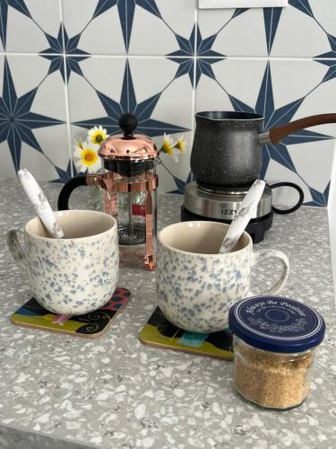 two cups sitting on top of a counter at Blue Bergamote Syros in Ermoupoli