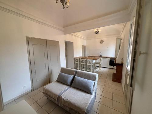 un salon avec un canapé et une cuisine dans l'établissement Rêve de Vacances Insolite Palais Lascaris Vue Montagne et Village Médiéval, à Castellar