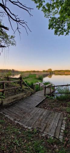 a wooden bridge over a body of water at Castle Lakes - Apartamenty in Legnica
