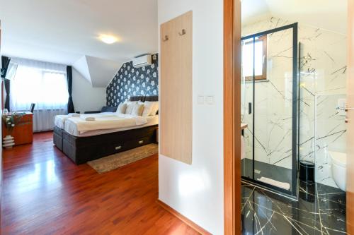 a bedroom with a bed and a glass door at Pansion Villa Cancar in Grabovac