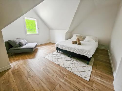 a bedroom with a bed with a teddy bear on it at Villa Marine, Jacuzzi, 25' Disneyland in La Celle-sur-Morin