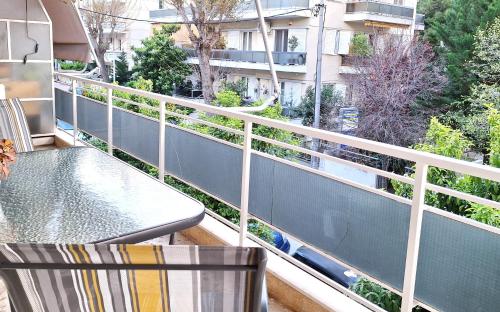 a balcony with a table and a chair at Carlito apartment 1 next to metro station in Athens