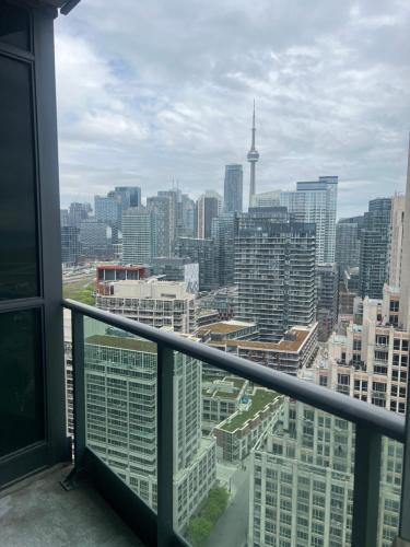 a view of a city skyline from a balcony at Downtown Toronto Suite By The Water in Toronto
