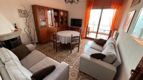 a living room with two couches and a dining room at VillaMarinaPigra Lake View Apartments in Pigra