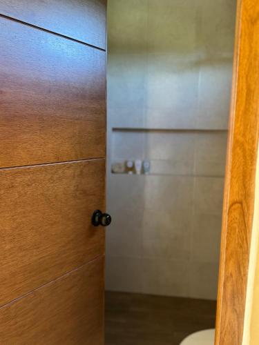 an open door to a bathroom with a closet at Otoch Maya in Valladolid