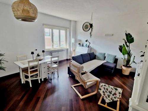 a living room with a couch and a table at Santa Maria Apartment in Civitavecchia