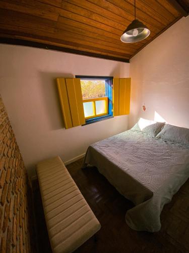 オウロ・プレットにあるRecanto do Sol - Lavras Novasのベッドと窓のある寝室