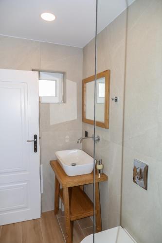 a bathroom with a sink and a shower at Heaven Apartments in Agia Marina Nea Kydonias