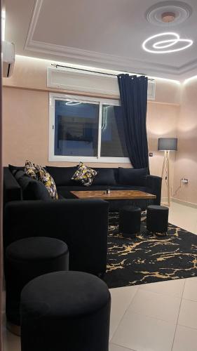 a living room with a couch and a table at Yousa Home & pool in Gzennaïa