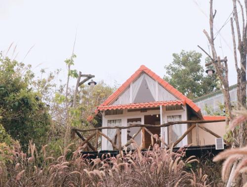 a small house in the middle of a field at Dreamers Garden Farmstay in Hoat