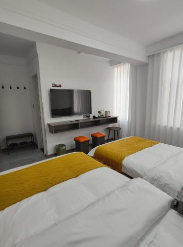 Postel nebo postele na pokoji v ubytování Little Mango Inn