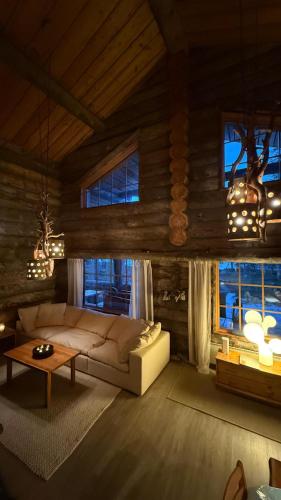 a living room with a couch and a table at Kelokantola by the lake in Ruka