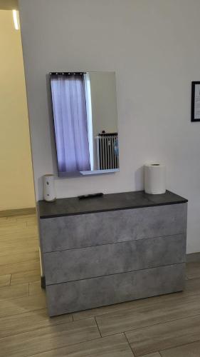 a dresser with a mirror on top of it at Casa Manzoni in Novara