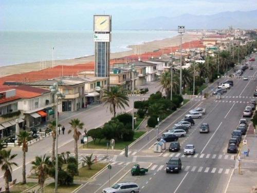 a city with cars parked on a street next to the beach at I Levrieri in Torre del Lago Puccini