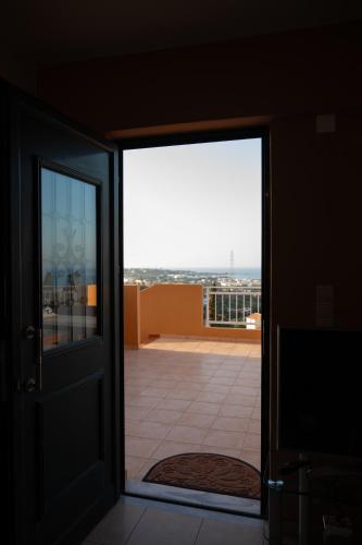 an open door to a balcony with a view at Sina Family in Piskopianon