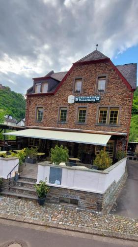 a brick building with a sign on it at Gasthaus Rosenberg in Klotten