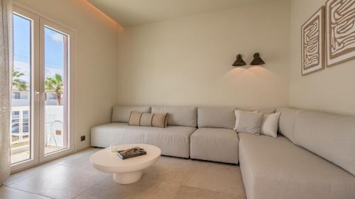 a living room with a couch and a table at Hotel Eleni in Adamas