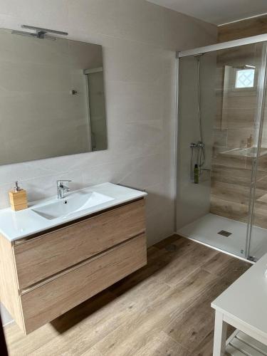a bathroom with a sink and a shower at Casa Kiros in Cangas de Morrazo