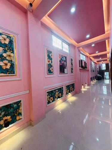 a hallway with paintings on the walls of a building at Hotel Airport Suites Suitable for Hourly Bookings in Lucknow