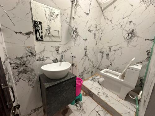 a bathroom with a sink and a toilet at Hotel Airport Suites Suitable for Hourly Bookings in Lucknow
