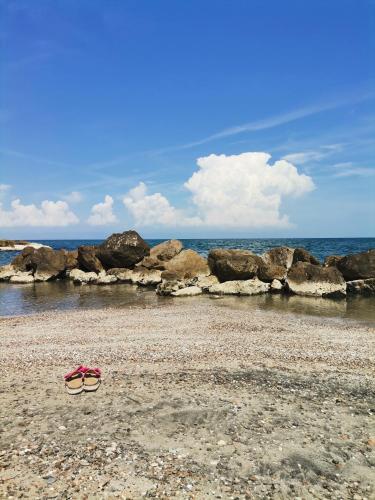 a pair of glasses sitting on the beach at Vista Mare Luxury Rooms & Apartments in Margherita di Savoia